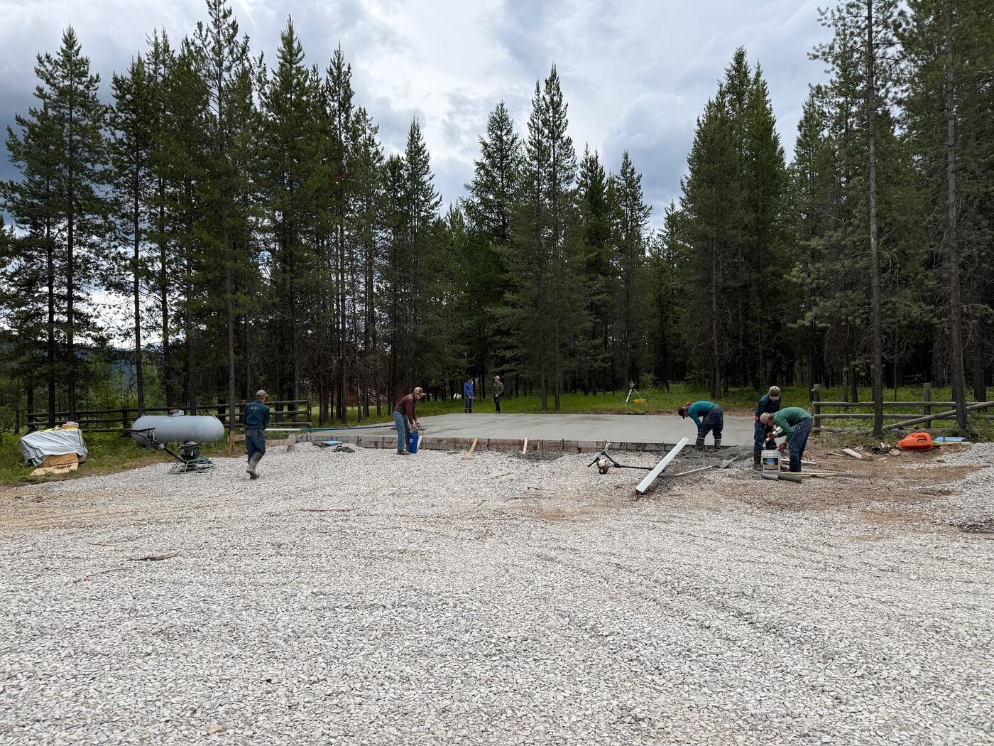 The completed slab from the gravel apron with the crew cleaning up