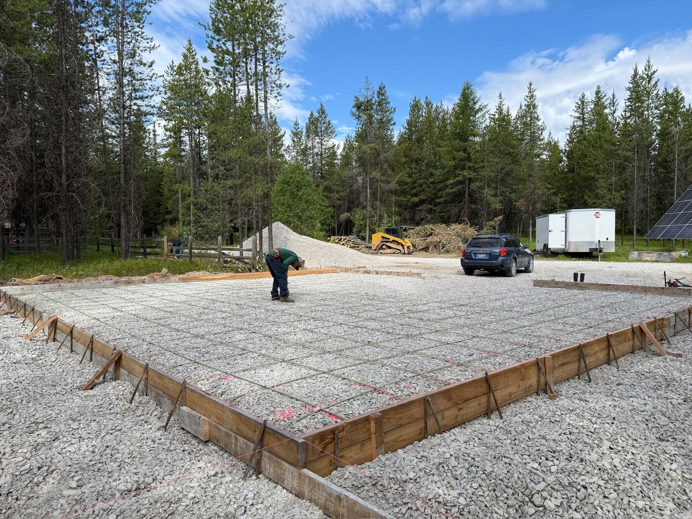 Edge forms and a tied rebar mat covering the finished pad, ready to pour