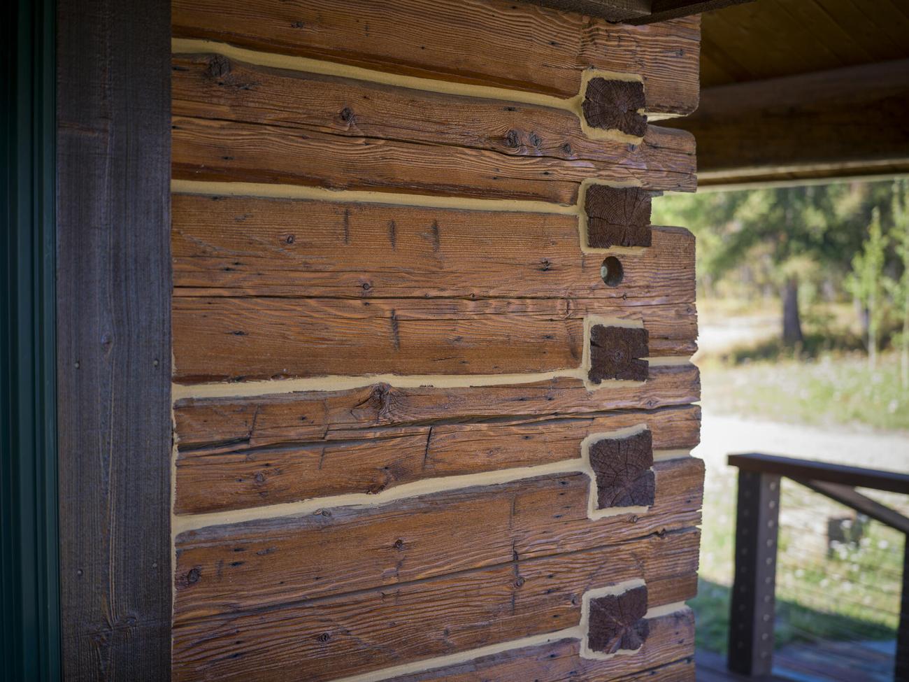 Chinked log wall with a hand-cut corner notch